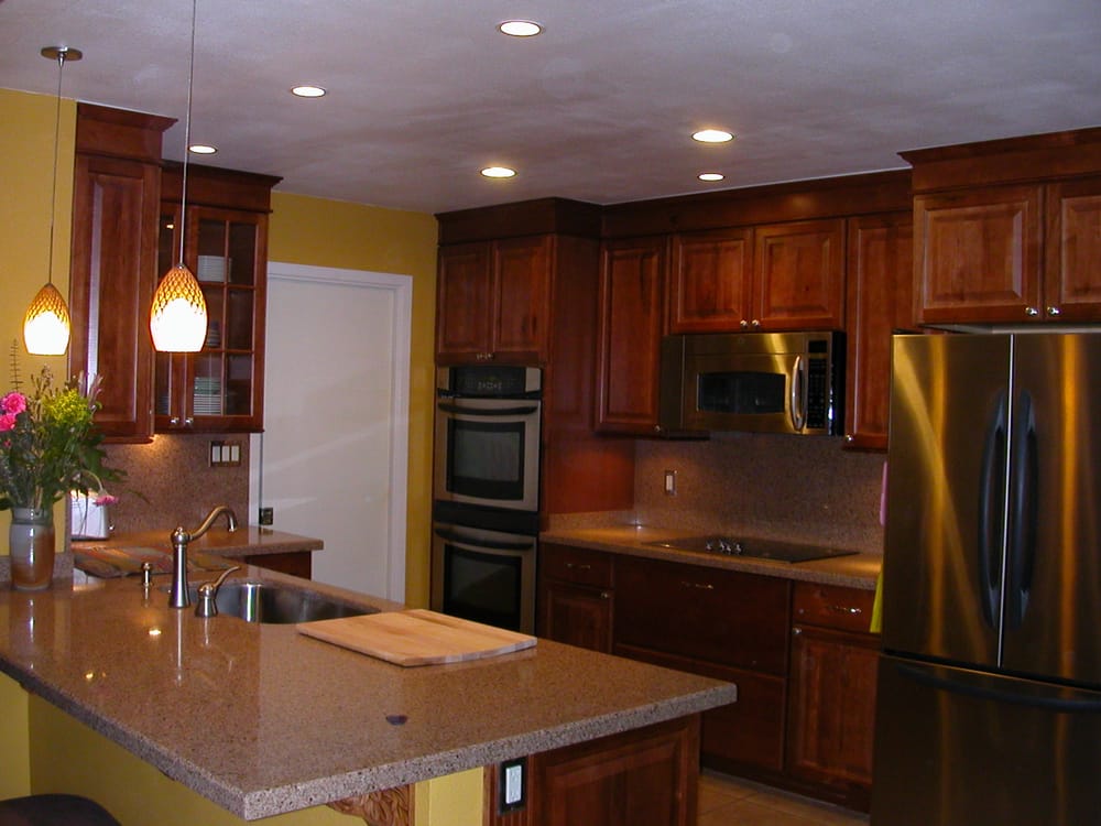 Kitchen remodel with recessed lighting, under cabinet lighting and hanging pendant lights